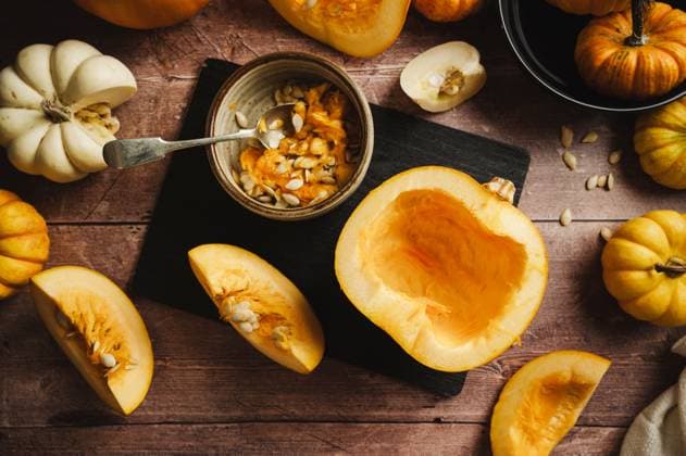 Rustic dark still life with sliced pumpkin and seeds in autumn kitchen model released, Symbolfoto property released, IGEF00163
