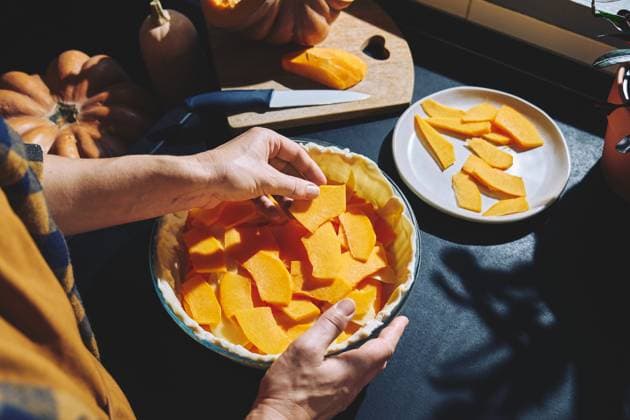 Woman preparing homemade pumpkin pie in kitchen with autumn ingredients model released, Symbolfoto property released, CATF00810