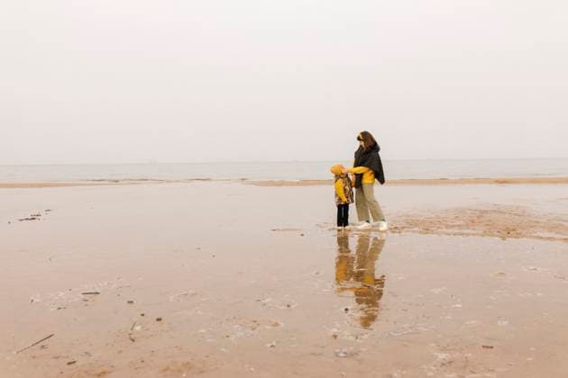 Mother and child embracing and connecting on an autumn beach day model released, Symbolfoto, VIVF01704