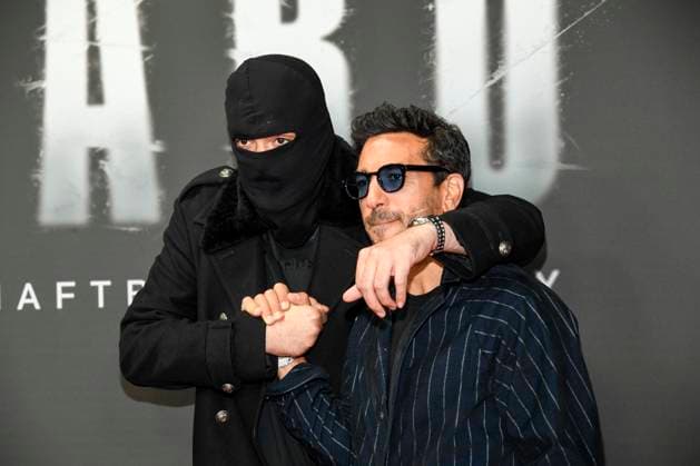 abb Haftbefehl Aykut Anhan with balaclava and Elyas M Barek as guests on the red carpet of the special screening event of the Netflix documentary highlight Babo The Haftbefehl Story at the Astor Film Lounge on 24 10 2025in Berlin Berlin Germany