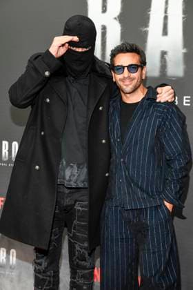 abb Haftbefehl Aykut Anhan with balaclava and Elyas M Barek as guests on the red carpet of the special screening event of the Netflix documentary highlight Babo The Haftbefehl Story at the Astor Film Lounge on 24 10 2025in Berlin Berlin Germany