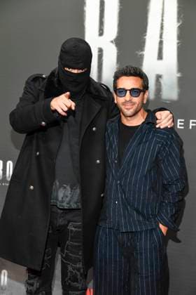 abb Haftbefehl Aykut Anhan with balaclava and Elyas M Barek as guests on the red carpet of the special screening event of the Netflix documentary highlight Babo The Haftbefehl Story at the Astor Film Lounge on 24 10 2025in Berlin Berlin Germany