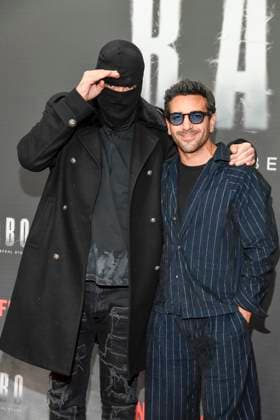 abb Haftbefehl Aykut Anhan with balaclava and Elyas M Barek as guests on the red carpet of the special screening event of the Netflix documentary highlight Babo The Haftbefehl Story at the Astor Film Lounge on 24 10 2025in Berlin Berlin Germany