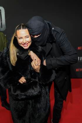 abb Haftbefehl Nina Anhan with Aykut Anhan with balaclava on the red carpet of the special screening event of the Netflix documentary highlight Babo The Haftbefehl Story at the Astor Film Lounge on 24 10 2025in Berlin Berlin Germany