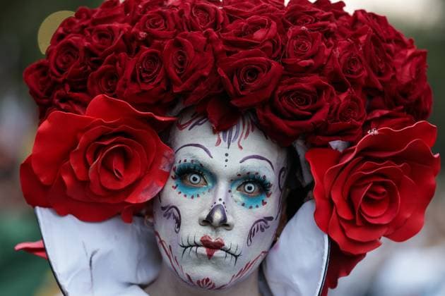 (251027) -- MEXICO CITY, Oct. 27, 2025 -- A participant with facial makeup takes part in the Catrinas Parade in Mexico City, capital of Mexico, on Oct. 26, 2025. The Catrinas Parade was held on Sunday ahead of the Day of the Dead. (Photo by Francisco Canedo Xinhua) MEXICO-MEXICO CITY-PARADE-CATRINAS LixMengxin 