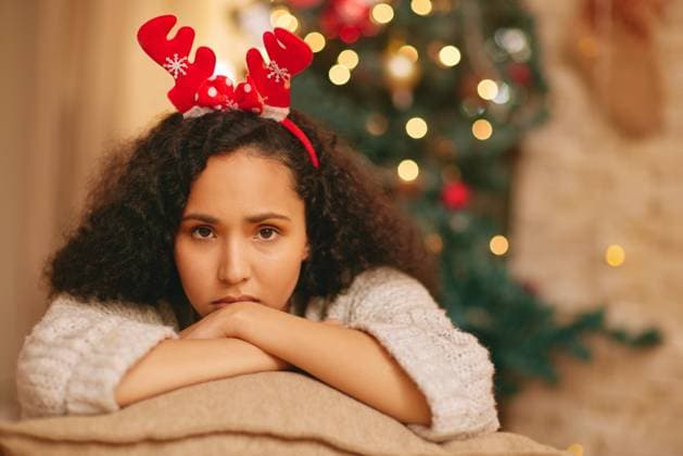 Portrait, lonely and sad woman on sofa at Christmas with crisis, frustrated face and holiday in lounge at home. Mental health, vacation and girl with depression on couch in living room with xmas tree Portrait, lonely and sad woman on sofa at Christmas with crisis, frustrated face and holiday in lounge at home. Mental health, vacation and girl with depression on couch in living room with xmas tree., model released, , property released, , 59334814.jpg RECORD DATE NOT STATED