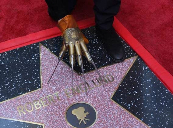 American actor and director Robert Englund, who is best known for his portrayal of the villainous Freddie Krueger kneels next to his star during an unveiling ceremony honoring him with the 2, 826th star on the Hollywood Walk of Fame in Los Angeles on Friday, October 31, 2025.  LAP20251031133 JIMxRUYMEN