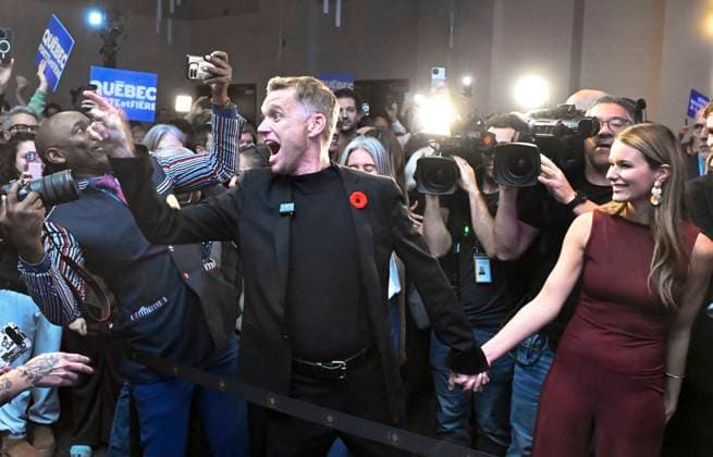 November 2, 2025, Quebec, Pq, Canada: Bruno Marchand reacts to his re-election as mayor of Quebec City during celebrations in Quebec City, Sunday, Nov. 2, 2025. Marchand s life partner Monic Neron, right, looks on. Quebec Canada  - ZUMAc35_ 20251102_zaf_c35_252 Copyright: xJacquesxBoissinotx