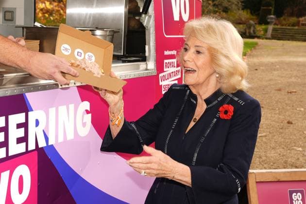 Community volunteering celebration Queen Camilla is served from Spudman as he delivers jacket potatoes in a Royal Voluntary Service food truck, as she hosts members of the National Association of Care Catering (NACC), and representatives from Royal Voluntary Service (RVS) in a celebration of community volunteering during Meals on Wheels Week, at Clarence House in central London. Picture date: Wednesday November 5, 2025., Credit:Jordan Pettitt Avalon UK, London  Copyright: xJordanxPettittx xAvalonx 1050498449
