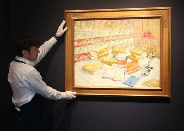 November 7, 2025, New York, New York, USA: A handler seen with Piles de romans parisiens et roses dans une verre (Romans parisiens), 1887, by artist Vincent Van Gogh, estimate $40 million, seen on display during November Marquee Week 2025 during SothebyÃ¢â‚¬â ¢s Opening of the New Global Headquarters at the Breuer. New York USA - ZUMAk03_ 20251107_zaf_k03_040 Copyright: xNancyxKaszermanx
