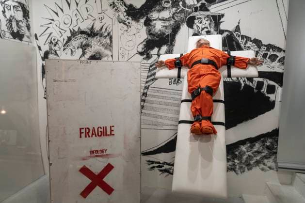 November 8, 2025, Basel, Basel-Stadt, Switzerland: A sculpture depicting the US President Donald Trump in a prisoner orange jumpsuit and strapped to a cross looking like a death row strapped-down bed, is displayed in a gallery of the city centre of Basel, Switzerland Basel Switzerland - ZUMAp199 20251108_zip_p199_008 Copyright: xMatteoxPlacuccix