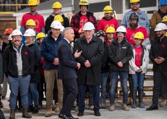 November 10, 2025, Fredericton, Nb, Canada: Prime Minister Mark Carney center, talks with workers at Maple Leaf Homes before making an announcement in Fredericton, N.B., on Monday, Nov. 10, 2025. Fredericton Canada  - ZUMAc35_ 20251110_zaf_c35_042 Copyright: xStephenxMacgillivrayx