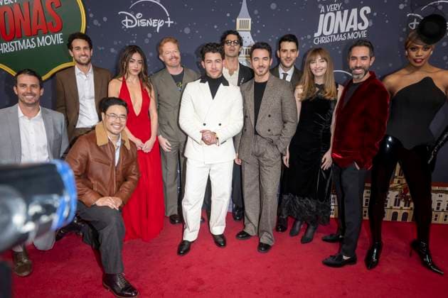 November 10, 2025, New York, United States: (L-R) Scott Morgan, Spencer Berman, Randall Park, Chloe Bennet, Jesse Tyler Ferguson, Nick Jonas, Joe Jonas, Kevin Jonas, Isaac Aptaker, Elizabeth Berger, Adam Fishbach and Laverne Cox attend Disney+ s A Very Jonas Christmas Movie New York Premiere at New York City Center. New York United States - ZUMAs197 20251110_aaa_s197_402 Copyright: xRonxAdarx