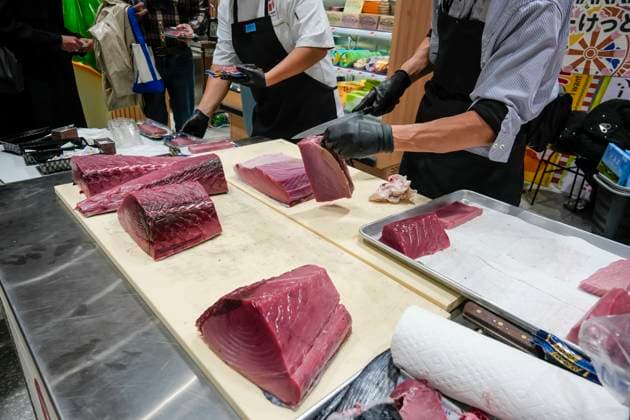 Display of sashimi prowess in New York Chef breaks down a tuna for sashimi in an asian supermarket in Greenwich Village in New York on Sunday, November 9, 2025. (  RichardxB.xLevine