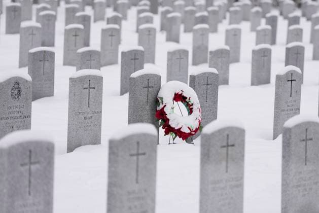 November 11, 2025, Ottawa, On, Canada: A snow-covered wreath leans against a gravestone ahead of a Remembrance Day ceremony at the national military Cemetery at Beachwood in Ottawa on Tuesday, Nov. 11, 2025. Ottawa Canada  - ZUMAc35_ 20251111_zaf_c35_008 Copyright: xJustinxTangx