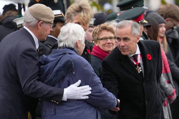 November 11, 2025, Ottawa, On, Canada: Prime Minister Mark Carney, right, greets National Silver Cross Mother, Mrs. Nancy Payne, of Lansdowne, Ont., during a Remembrance Day ceremony in Ottawa on Tuesday, Nov. 11, 2025. Ottawa Canada - ZUMAc35_ 20251111_zaf_c35_018 Copyright: xSeanxKilpatrickx