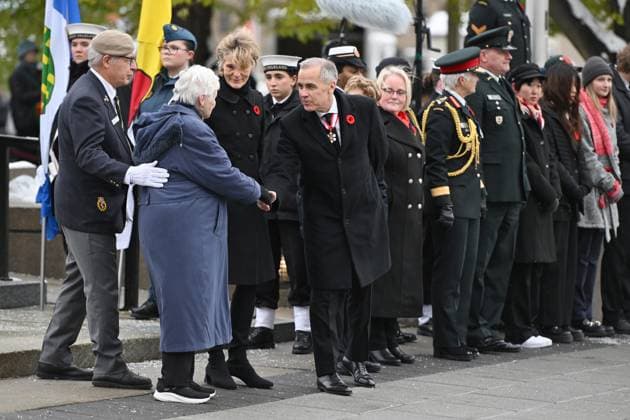 November 11, 2025, Ottawa, On, Canada: Prime Minister Mark Carney, right, greets National Silver Cross Mother, Mrs. Nancy Payne, of Lansdowne, Ont., during a Remembrance Day ceremony in Ottawa on Tuesday, Nov. 11, 2025. Ottawa Canada - ZUMAc35_ 20251111_zaf_c35_020 Copyright: xSpencerxColbyx