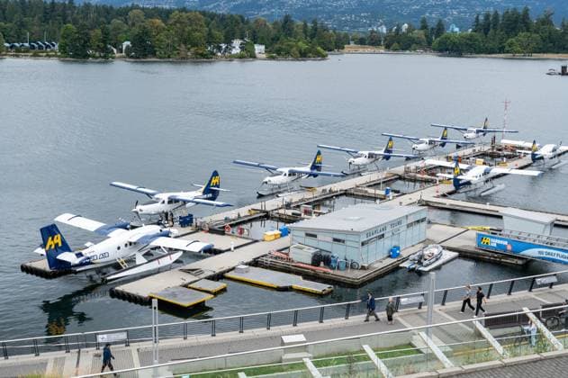 16 08 2025, Vancouver, British Columbia, Canada Harbour Air turboprop seaplanes parked at the Seaplane Terminal jetty in Vancouver Harbour