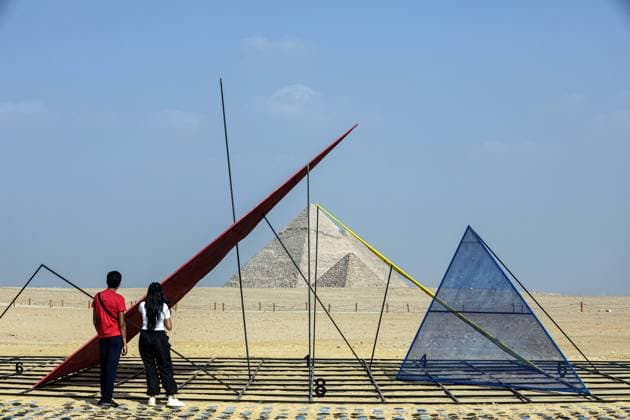 (251111) -- CAIRO, Nov. 11, 2025 -- Visitors view an artwork exhibited during the Forever Is Now international art exhibition at Giza Pyramids scenic spot in Giza, Egypt, Nov. 11, 2025. The fifth edition of Forever Is Now international art exhibition on Tuesday kicked off in the area of Egypt s Giza Pyramids scenic spot, showcasing 10 artworks of artists from different countries. The exhibition runs from Nov. 11 to Dec. 6. Ahmed Gomaa) EGYPT-GIZA-PYRAMIDS-ART EXHIBITION-FOREVER IS NOW AixHamaide¡¤gema 