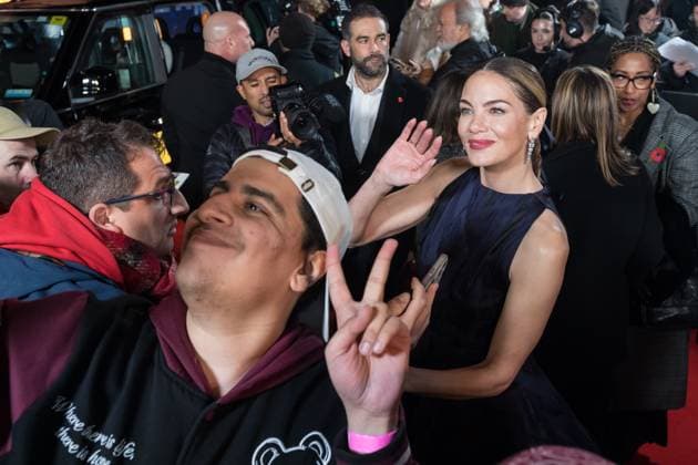 November 11, 2025, London, England, United Kingdom: MICHELLE MONAGHAN poses for a selfie with a fan as she attends the World Premiere of The Family Plan 2 at Curzon Mayfair in London. London United Kingdom - ZUMAs371 20251111_zip_s371_054 Copyright: xWiktorxSzymanowiczx