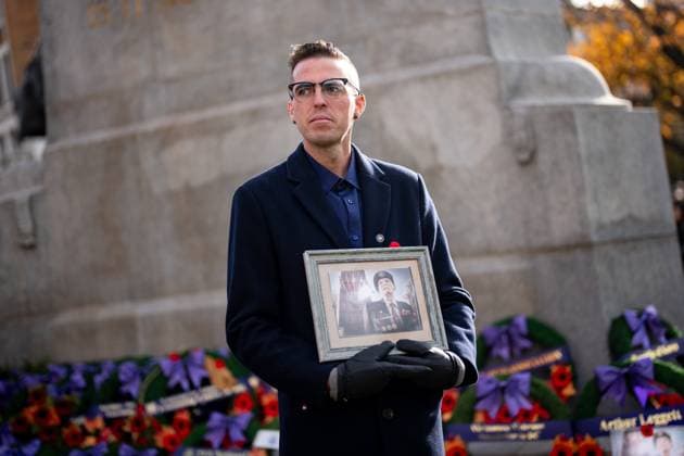 November 11, 2025, Vancouver, Bc, CANADA: Markus McNeilly holds a picture of his grandfather Arthur Leggatt, who served in the Korean War, during a Remembrance Day ceremony, in Vancouver, B.C., Tuesday, Nov. 11, 2025. Vancouver CANADA - ZUMAc35_ 20251111_zaf_c35_240 Copyright: xEthanxCairnsx