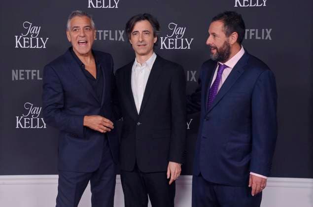Director Noah Baumbach (C) and cast members George Clooney (L) and Adam Sandler attend the premiere of Netflix s dramatic comedy Jay Kelly at the Egyptian Theatre in the Hollywood section of Los Angeles on Tuesday, November 11, 2025. Storyline: Famous movie actor Jay Kelly embarks on a journey of self-discovery, confronting his past and present with his devoted manager Ron. Poignant and humor-filled, pitched at the intersection of regrets and glories.  LAP2025111116 JIMxRUYMEN