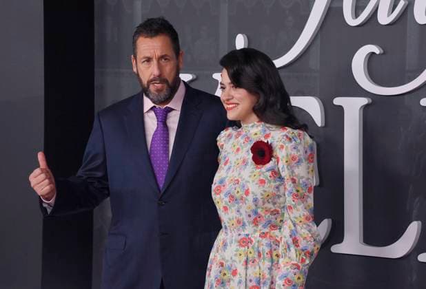Cast members Adam Sandler (L) and Grace Edwards attend the premiere of Netflix s dramatic comedy Jay Kelly at the Egyptian Theatre in the Hollywood section of Los Angeles on Tuesday, November 11, 2025. Storyline: Famous movie actor Jay Kelly embarks on a journey of self-discovery, confronting his past and present with his devoted manager Ron. Poignant and humor-filled, pitched at the intersection of regrets and glories.  LAP2025111117 JIMxRUYMEN