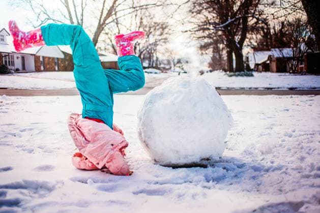 Girl upside down next to giant snowball Tulsa, Oklahoma, United States CR_KRRY251110-1877513-01