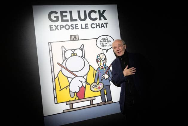 Exhibition of Philippe Geluck - Paris AJ Portrait of Philippe Geluck who pose next to a poster for the exhibition during the opening of the exhibition (vernissage) of Philippe Geluck, author of the comic book (Bande dessinee, BD, Livre) strip Le Chat at the Maillol Museum in Paris, France on November 12, 2025. Photo by Alexis Jumeau ABACAPRESS.COM Paris France  Copyright: xJumeauxAlexis ABACAx