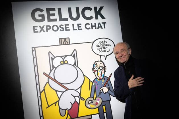 Exhibition of Philippe Geluck - Paris AJ Portrait of Philippe Geluck who pose next to a poster for the exhibition during the opening of the exhibition (vernissage) of Philippe Geluck, author of the comic book (Bande dessinee, BD, Livre) strip Le Chat at the Maillol Museum in Paris, France on November 12, 2025. Photo by Alexis Jumeau ABACAPRESS.COM Paris France  Copyright: xJumeauxAlexis ABACAx