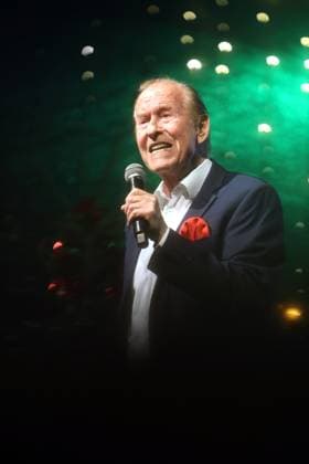 German music legends Born on July 29, 1943, Lothar Bernhard Walter, who achieved great success as a pop singer and film actor under his stage name Michael Holm, sings on a stage in Essen Steele at the local Christmas market in the run-up to Christmas Essen North Rhine-Westphalia Germany Steele