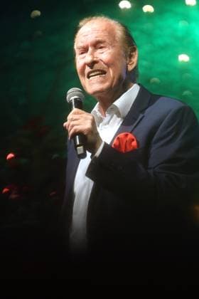 German music legends Born on July 29, 1943, Lothar Bernhard Walter, who achieved great success as a pop singer and film actor under his stage name Michael Holm, sings on a stage in Essen Steele at the local Christmas market in the run-up to Christmas Essen North Rhine-Westphalia Germany Steele