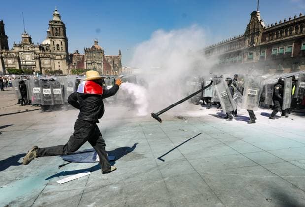 A person confronts riot police during the Ã¢â‚¬ËœGen ZÃ¢â‚¬â ¢ demonstration at main square Zocalo against the Mexican government following the murder of Uruapan Mayor Carlos Manzola, while Mexico s President, Claudia Sheinbaum, has questioned the legitimacy of the movement in recent days . on November 15, 2025 in Mexico City, Mexico. Mexico City Mexico - ZUMAe321 20251115_zia_e321_077 Copyright: xIanxRoblesx