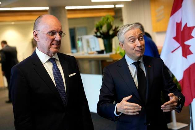 November 19, 2025, Ottawa, On, CAN: Minister of Finance and National Revenue Francois-Philippe Champagne and Jan Carlson, chair of Ericsson s board of directors, left, await the arrival of Sweden s King Carl XVI Gustaf and Queen Silvia, not shown, at the Ericsson Research & Development facility in Ottawa, on Wednesday, Nov. 19, 2025. Ottawa CAN - ZUMAc35_ 20251119_zaf_c35_042 Copyright: xJustinxTangx