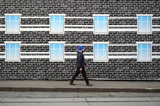 Russia Daily Life 9050391 19.11.2025 A man walks past a construction site banner in Moscow, Russia. Pelagiya Tikhonova Sputnik Moscow Russia  Copyright: xPelagiyaxTikhonovax