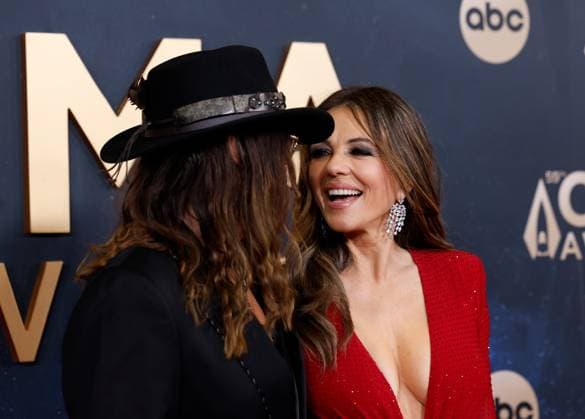 (L-R) Billy Ray Cyrus and Elizabeth Hurley arrive on the red carpet for the 59th CMA Awards in Nashville, Tennessee, on Wednesday, November 19, 2025.  NAS20251119241 JOHNxANGELILLO