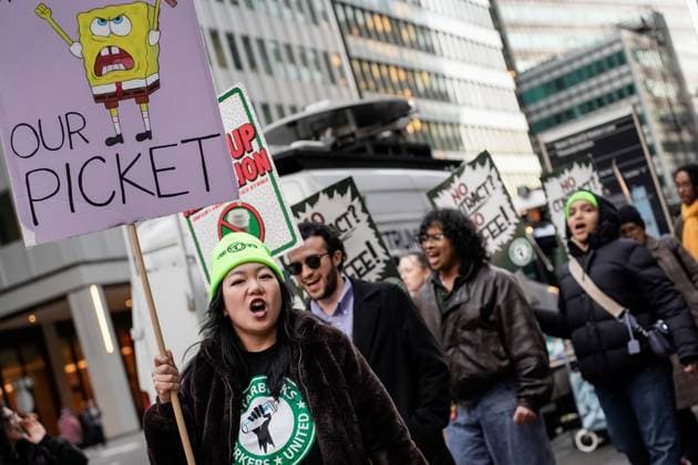November 20, 2025, Manhattan, United States: A Starbuck employees chants while picketing outside a Starbucks storefront. Outside the 155 Water Street location, workers picket to demand fair pay, better working hours, and an end to unfair labor practices for union busting. Manhattan United States - ZUMAs197 20251120_aaa_s197_195 Copyright: xDerekxFrenchx