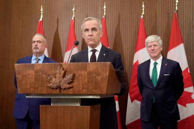 November 26, 2025, Ottawa, On, Canada: Dofasco CEO Ron BÃ dard and Minister of Energy and Natural Resources Tim Hodgson(right) look on as Prime Minister Mark Carney is seen during a news conference in Ottawa, Wednesday, Nov. 26, 2025. Ottawa Canada  - ZUMAc35_ 20251126_zaf_c35_074 Copyright: xAdrianxWyldx