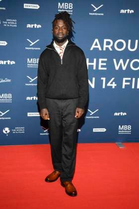 ABBberlin Mohamed Ndiaye on the red carpet at the festival opening AROUND THE WORLD IN 14 FILMS at Cinestar Kino in der Kulturbrauerei Berlin on 28 11 2025 Berlin Germany