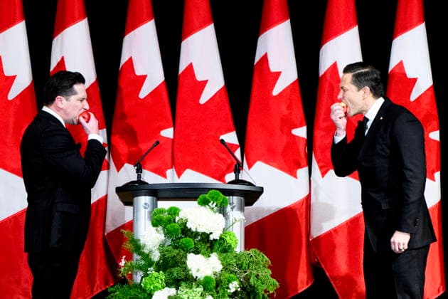 November 29, 2025, Ottawa, On, Canada: Leader of the Conservative Party Pierre Poilievre, right, takes a bite of an apple while staring down comedian Chris Wilson during the Parliamentary Press Gallery Dinner in Ottawa, on Saturday, Nov. 29, 2025. Ottawa Canada  - ZUMAc35_ 20251129_zaf_c35_099 Copyright: xSpencerxColbyx