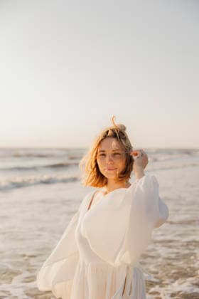 Woman dancing on the beach near the ocean at sunset Amsterdam, North Holland, Netherlands CR_RTBZ251117A-1890406-01 ,model released, Symbolfoto