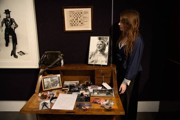 Bonhams Sound & Cinema: With Property from The Marianne Faithfull Estate Sale - Bonhams, London, UK - 1 December 2025 A staff member views (bottom) - A Large Collection of Photographs, some professional and some personal owned by Marianne Faithfull (est. Â£600 - Â£800) and (top) - Work on paper, titled Babylon by Anita Pallenberg (est. Â£800 - Â£1k) which is on auction at Bonhams Sound & Cinema: With Property from The Marianne Faithfull Estate Sale ending from 3rd December 2025 at Bonhams in London, England, UK on Monday 1 December, 2025., Credit:Justin Ng Avalon UK, England, London, Bonhams  Copyright: xJustinxNgx xAvalonx 1055809859