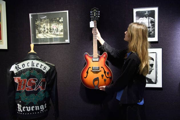 Bonhams Sound & Cinema: With Property from The Marianne Faithfull Estate Sale - Bonhams, London, UK - 1 December 2025 A staff member views (L) - A Custom-Made Jacket for the live Faith Tour owned by George Michael (est. Â£4k - Â£6k)and (R) - A Guild Starfire IV Electric Guitar Used On Blur s This Is A Low owned by Andy Ross (who discovered Blur) and played by Graham Coxon of Blur (est. Â£3k - Â£5k) which is on auction at Bonhams Sound & Cinema: With Property from The Marianne Faithfull Estate Sale ending from 3rd December 2025 at Bonhams in London, England, UK on Monday 1 December, 2025., Credit:Justin Ng Avalon UK, England, London, Bonhams  Copyright: xJustinxNgx xAvalonx 1055809870