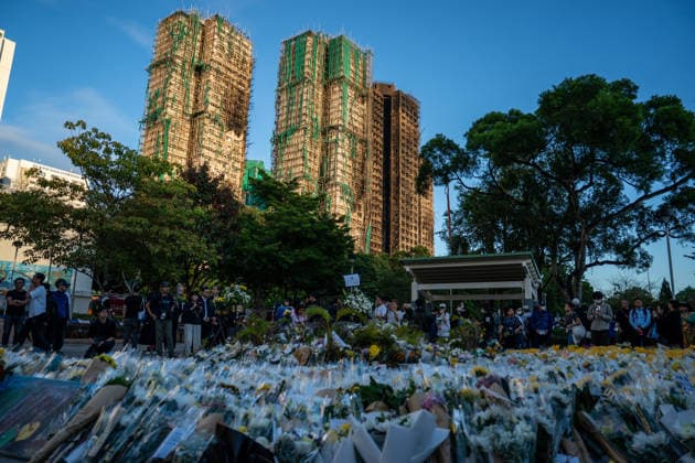 Hong Kong Building Fire Aftermath Flowers on the ground at a makeshift memorial near Wang Fuk Court housing complex in Tai Po following a deadly fire on December 1, 2025 in Hong Kong. (Photo by Vernon Yuen Nexpher Images) Hong Kong
