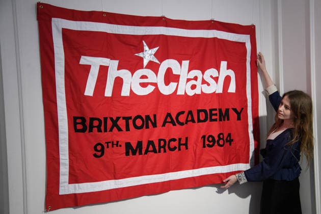 Bonhams Sound & Cinema: With Property from The Marianne Faithfull Estate Sale - Bonhams, London, UK - 1 December 2025 A staff member views Louis Theroux s First Concert - sewn cotton red banner, with The Clash Brixton Academy 9th March 1984 embroidered to centre of banner by Jeremy Deller x Louis Theroux (est. Â£8k - Â£10k) which is on auction at Bonhams Sound & Cinema: With Property from The Marianne Faithfull Estate Sale ending from 3rd December 2025 at Bonhams in London, England, UK on Monday 1 December, 2025., Credit:Justin Ng Avalon UK, England, London, Bonhams  Copyright: xJustinxNgx xAvalonx 1055809929