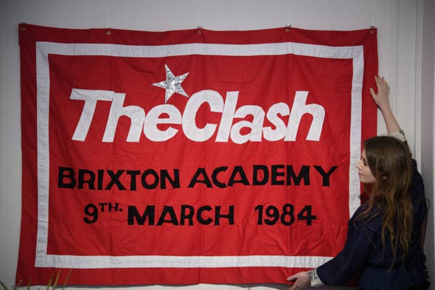Bonhams Sound & Cinema: With Property from The Marianne Faithfull Estate Sale - Bonhams, London, UK - 1 December 2025 A staff member views Louis Theroux s First Concert - sewn cotton red banner, with The Clash Brixton Academy 9th March 1984 embroidered to centre of banner by Jeremy Deller x Louis Theroux (est. Â£8k - Â£10k) which is on auction at Bonhams Sound & Cinema: With Property from The Marianne Faithfull Estate Sale ending from 3rd December 2025 at Bonhams in London, England, UK on Monday 1 December, 2025., Credit:Justin Ng Avalon UK, England, London, Bonhams  Copyright: xJustinxNgx xAvalonx 1055809936