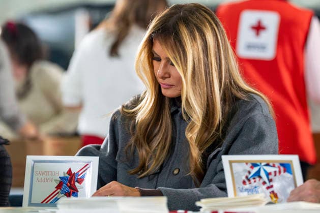 First Lady Melania Trump writes a letter for care packages for deployed Service members with during an event with Second Lady Usha Vance, the American Red Cross, U.S. Government Cabinet spouses and military spouses at Joint Base Andrews in Prince Georges County, Maryland on Monday, December 1, 2025.  WAP20251201357 BONNIExCASH