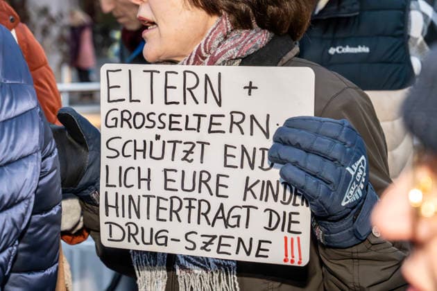 Right-wing demonstrator protests against drag queen reading for children with drag queen Vicky Voyage at Moosach public library, Munich, December 1, 2025 Germany, Munich, December 1, 202