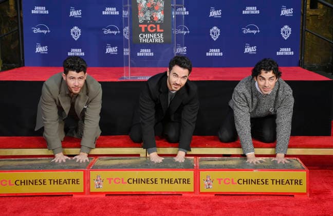 (L-R) Nick Jonas, Kevin Jonas and Joe Jonas of the Jonas Brothers participate in a hand and footprint ceremony immortalizing them in the forecourt of the TCL Chinese Theatre (formerly Grauman s) in the Hollywood section of Los Angeles on Wednesday, December 3, 2025.  LAP2025120304 JIMxRUYMEN