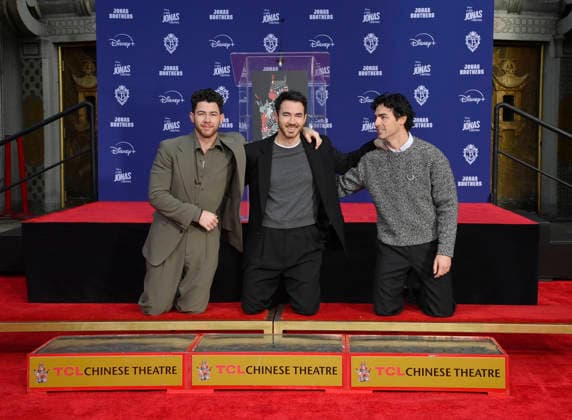 (L-R) Nick Jonas, Kevin Jonas and Joe Jonas of the Jonas Brothers participate in a hand and footprint ceremony immortalizing them in the forecourt of the TCL Chinese Theatre (formerly Grauman s) in the Hollywood section of Los Angeles on Wednesday, December 3, 2025.  LAP2025120308 JIMxRUYMEN